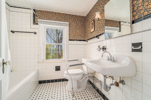 full bath featuring tile walls, toilet, and tile patterned floors