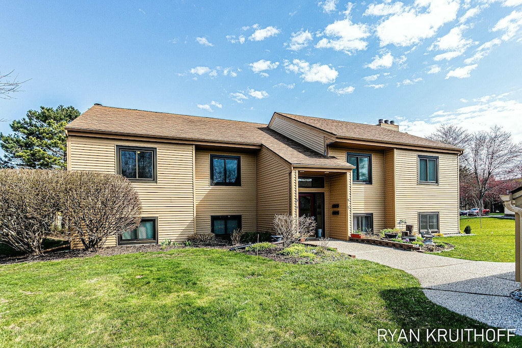 300 Farington Blvd Unit 43, Holland, MI 49423 - raised ranch with a chimney, roof with shingles, and a front yard