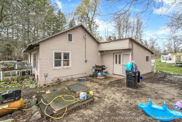 rear view of house with a wooden deck