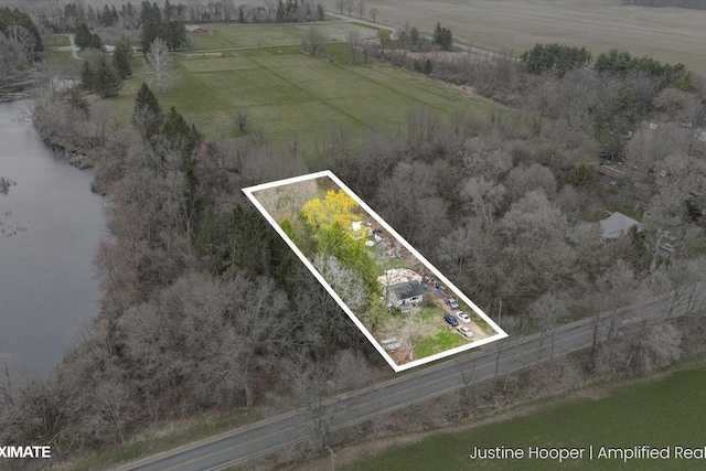 birds eye view of property with a rural view