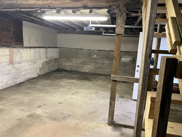 unfinished basement with concrete block wall