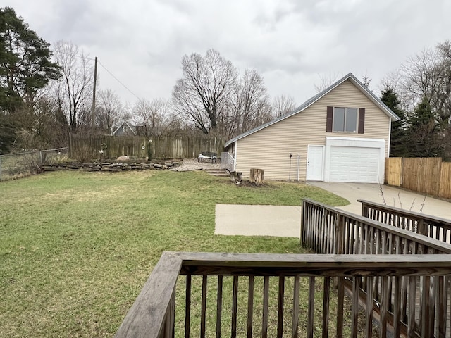 view of yard featuring fence and driveway