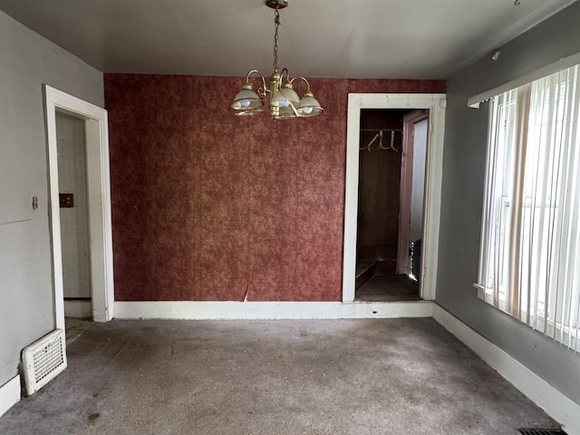 613 E Van Wagoner Ave, Flint, MI 48505 - unfurnished dining area with a chandelier, healthy amount of natural light, and baseboards