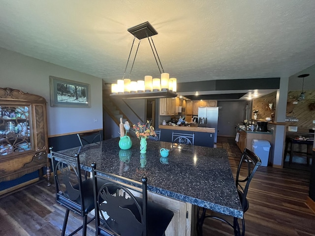 34722 36th Ave, Paw Paw, MI 49079 - dining room featuring dark wood finished floors, stairs, a textured ceiling, a chandelier, and baseboards