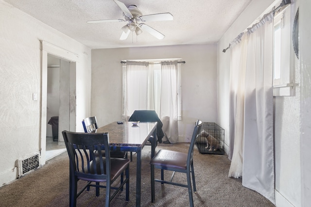dining space with ceiling fan, a textured ceiling, and carpet floors