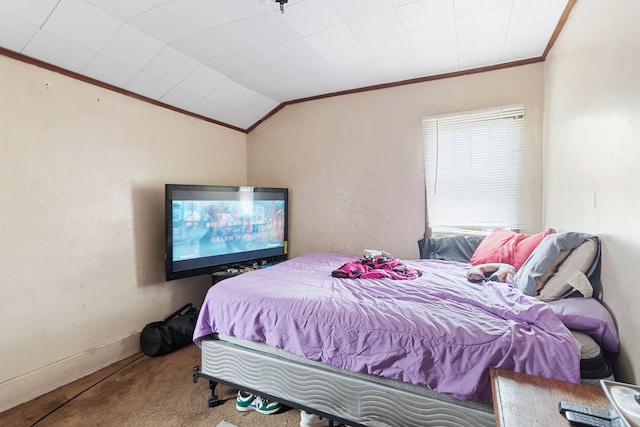 bedroom with ornamental molding, carpet floors, baseboards, and lofted ceiling