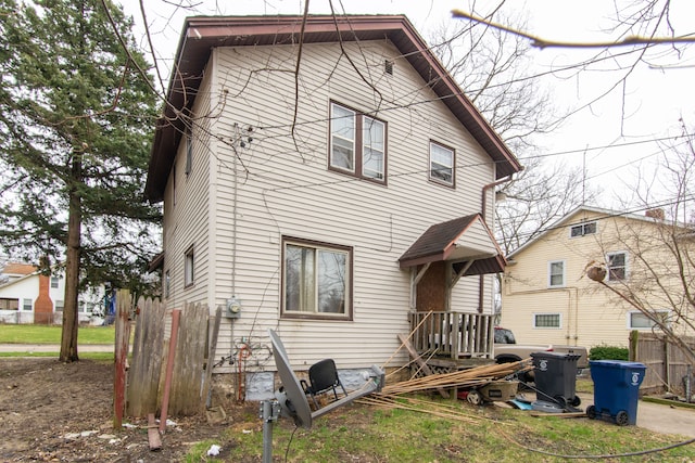 rear view of property featuring fence
