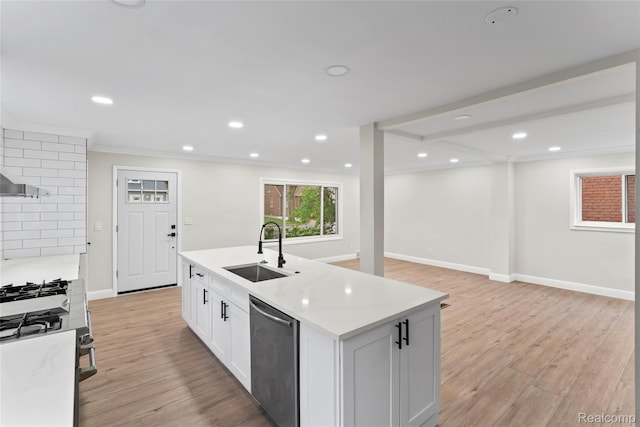 3761 Campbell St, Dearborn, MI 48124 - kitchen featuring stainless steel appliances, light wood finished floors, recessed lighting, a kitchen island with sink, and white cabinetry