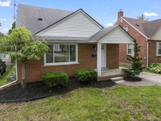 3761 Campbell St, Dearborn, MI 48124 - view of front of house featuring brick siding, roof with shingles, and a front yard