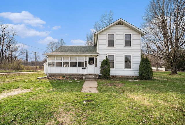 traditional-style home with a front lawn and roof with shingles