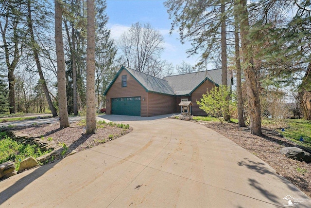 chalet / cabin featuring concrete driveway