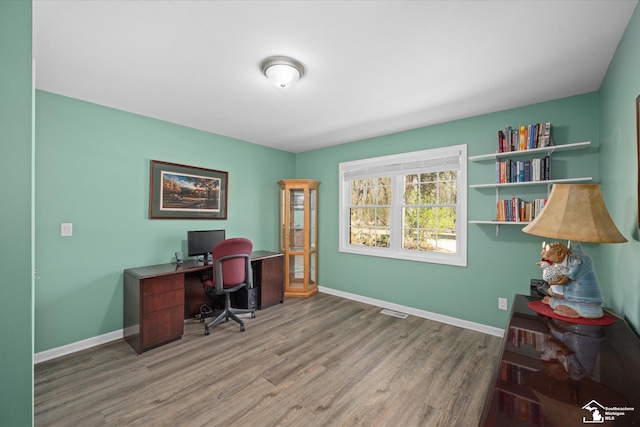 office area featuring wood finished floors, visible vents, and baseboards