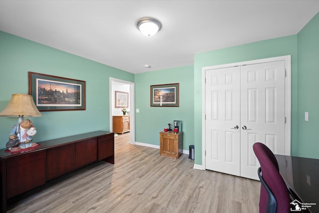 office area with baseboards and wood finished floors