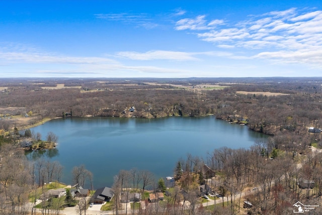 bird's eye view featuring a wooded view and a water view