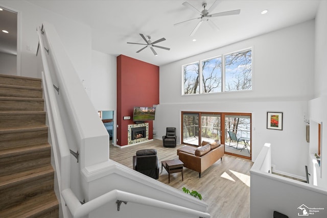 living area with recessed lighting, a high ceiling, and plenty of natural light