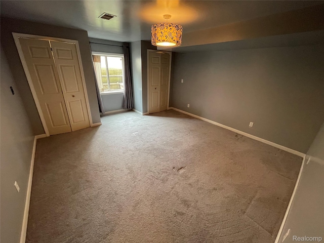 5652 N Lake Dr, Kimball, MI 48074 - unfurnished bedroom with baseboards and carpet flooring