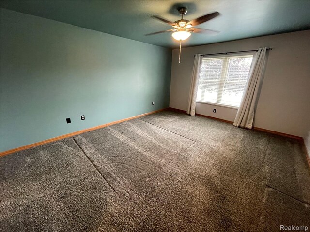 5652 N Lake Dr, Kimball, MI 48074 - carpeted spare room featuring baseboards and ceiling fan