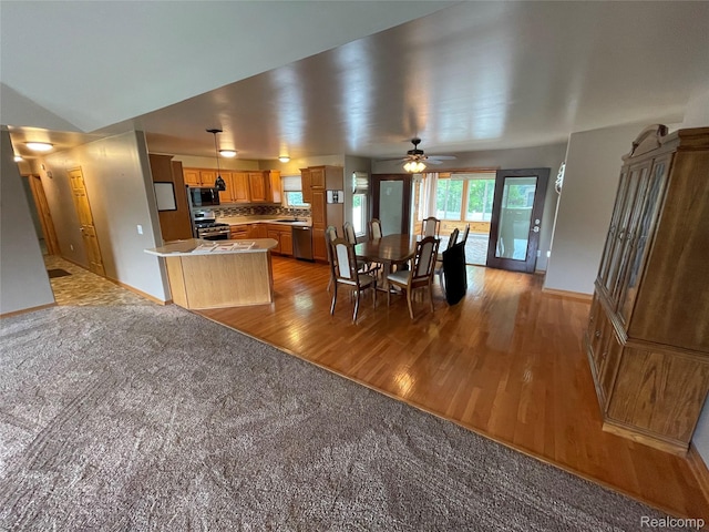 5652 N Lake Dr, Kimball, MI 48074 - kitchen with appliances with stainless steel finishes, light wood finished floors, a sink, light countertops, and baseboards