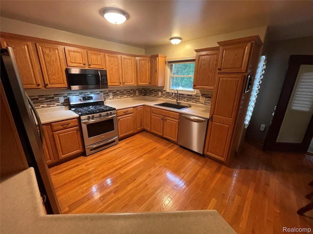 5652 N Lake Dr, Kimball, MI 48074 - kitchen with stainless steel appliances, decorative backsplash, light countertops, and light wood-style floors