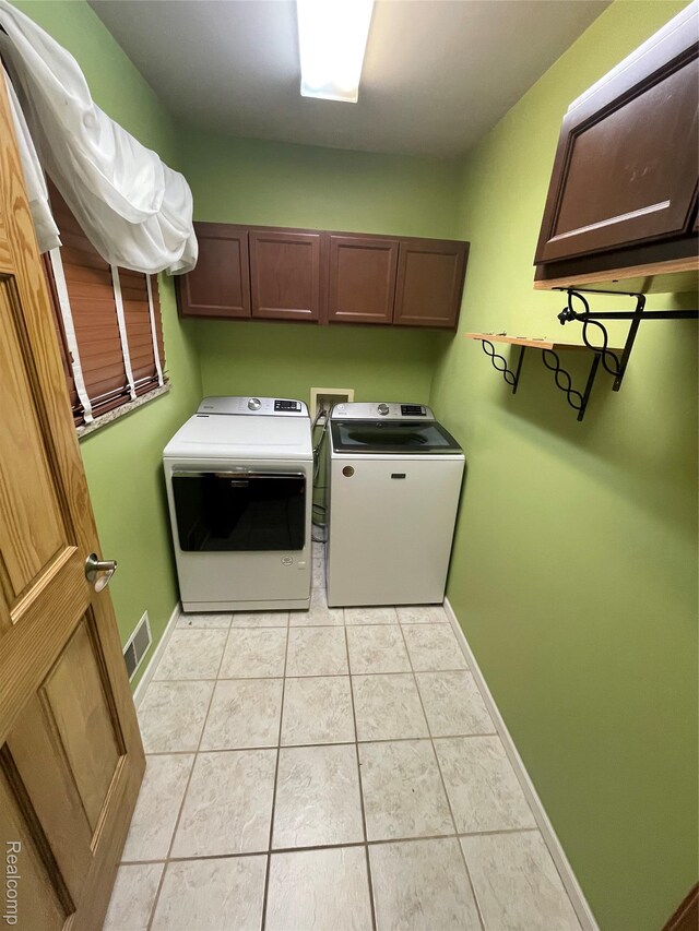 5652 N Lake Dr, Kimball, MI 48074 - laundry room featuring cabinet space, separate washer and dryer, and light tile patterned floors
