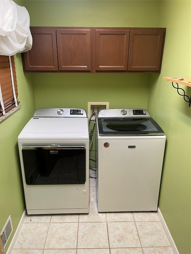 5652 N Lake Dr, Kimball, MI 48074 - laundry room with cabinet space, washer and clothes dryer, and light tile patterned floors