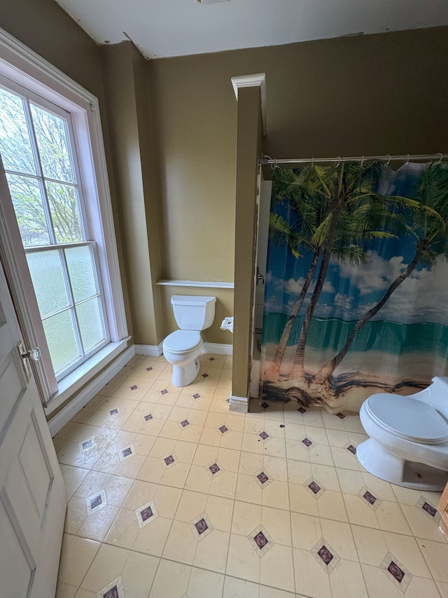 8083 S State Rd, Goodrich, MI 48438 - bathroom with toilet, baseboards, shower / bathtub combination with curtain, and tile patterned floors