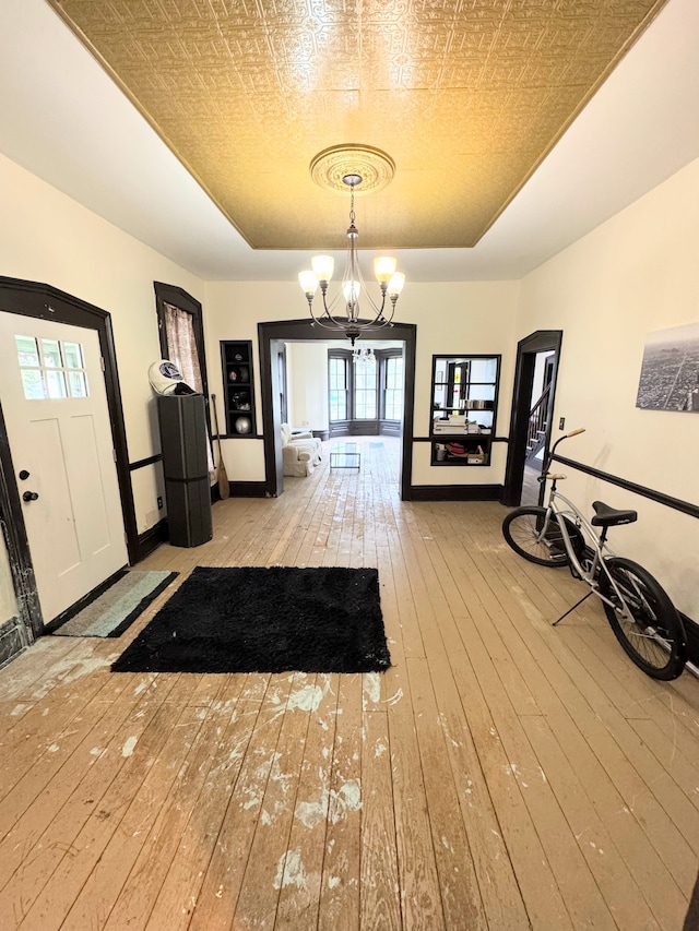 8083 S State Rd, Goodrich, MI 48438 - foyer with a raised ceiling, wood-type flooring, a chandelier, healthy amount of natural light, and an ornate ceiling