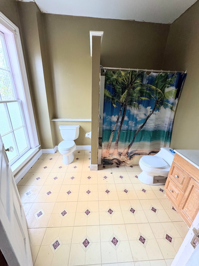8083 S State Rd, Goodrich, MI 48438 - full bathroom featuring toilet, healthy amount of natural light, and baseboards