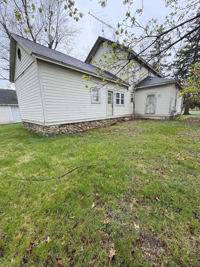 8083 S State Rd, Goodrich, MI 48438 - rear view of property featuring a lawn