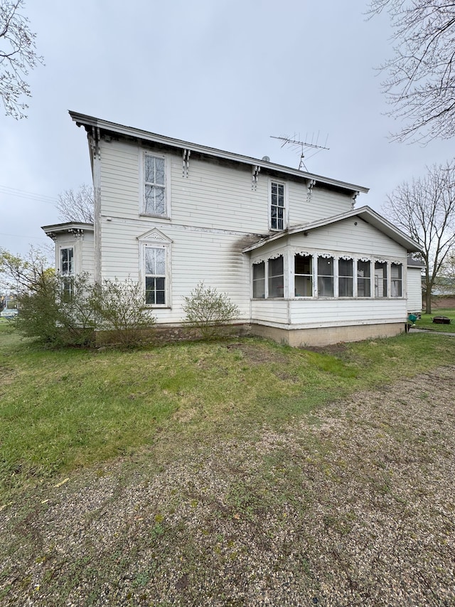 8083 S State Rd, Goodrich, MI 48438 - back of house featuring a sunroom and a yard