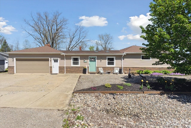 2510 Ruth Dr, Fenton, MI 48430 - view of front of property with brick siding, a garage, driveway, and a chimney