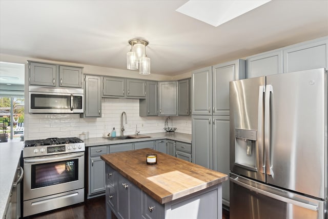 2510 Ruth Dr, Fenton, MI 48430 - kitchen with appliances with stainless steel finishes, gray cabinetry, butcher block counters, and a sink