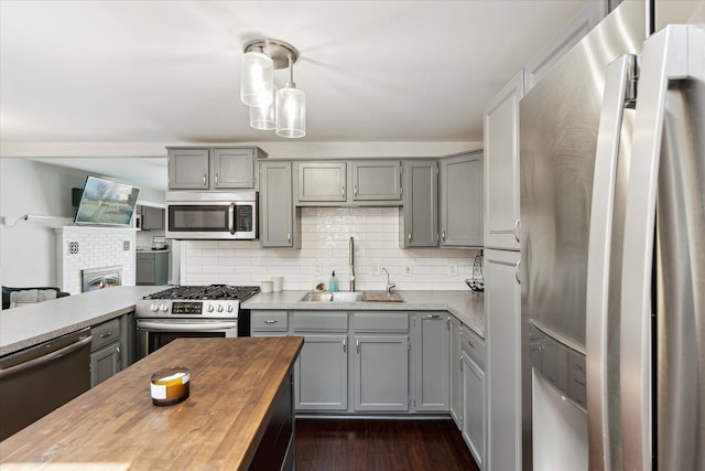 2510 Ruth Dr, Fenton, MI 48430 - kitchen with appliances with stainless steel finishes, gray cabinetry, a sink, and butcher block counters