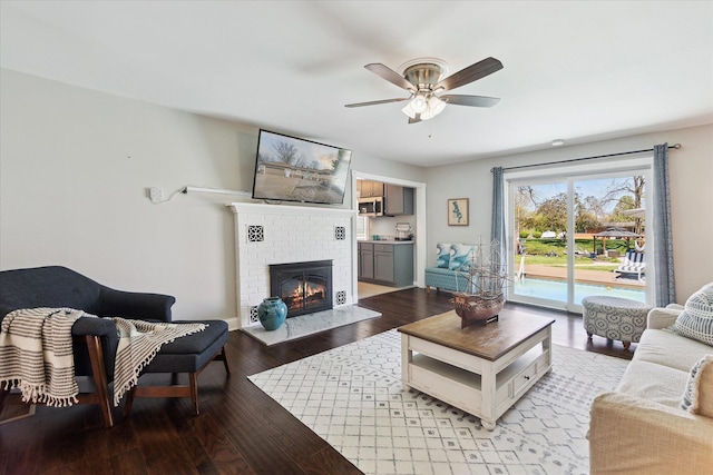 2510 Ruth Dr, Fenton, MI 48430 - living area featuring ceiling fan, a brick fireplace, light wood-type flooring, and baseboards