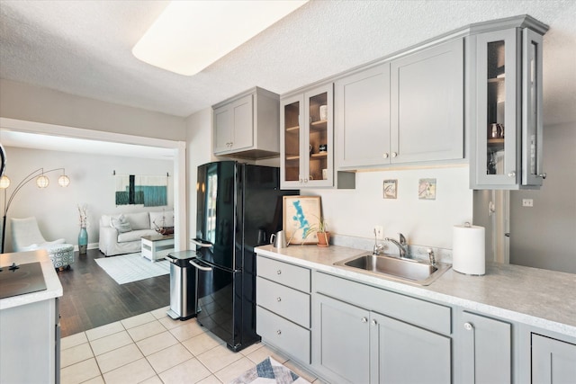2510 Ruth Dr, Fenton, MI 48430 - kitchen featuring freestanding refrigerator, a sink, gray cabinetry, light countertops, and a textured ceiling