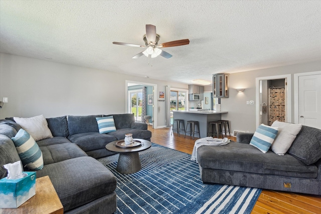 2510 Ruth Dr, Fenton, MI 48430 - living area featuring wood finished floors, a ceiling fan, and a textured ceiling