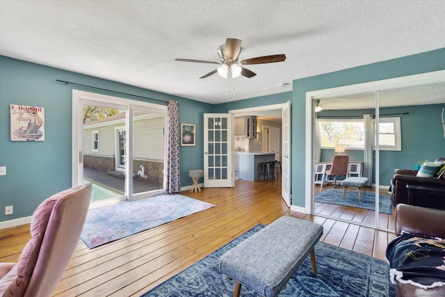 2510 Ruth Dr, Fenton, MI 48430 - living room with a ceiling fan, hardwood / wood-style floors, a textured ceiling, and baseboards
