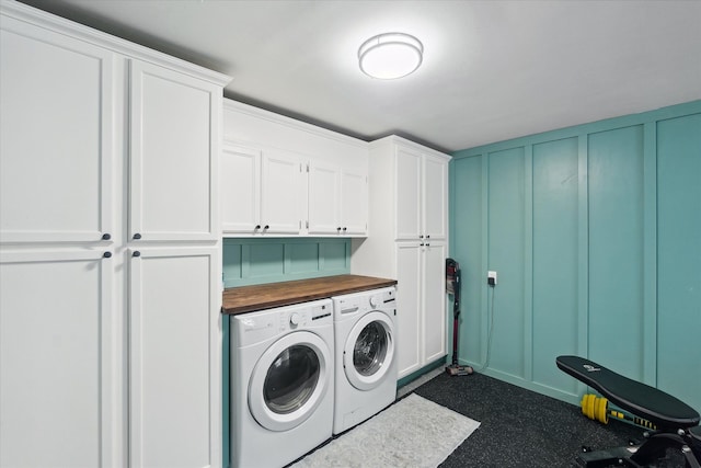 2510 Ruth Dr, Fenton, MI 48430 - laundry area featuring cabinet space, washer and clothes dryer, a decorative wall, and dark colored carpet