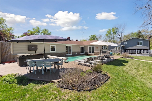 2510 Ruth Dr, Fenton, MI 48430 - back of house with a hot tub, a deck, an outdoor pool, and outdoor dining area