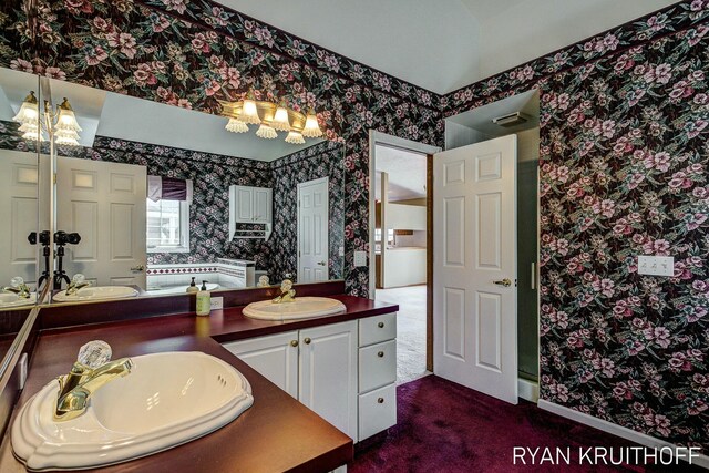 3076 Regency Pkwy, Zeeland, MI 49464 - bathroom with wallpapered walls, a bathing tub, and vanity