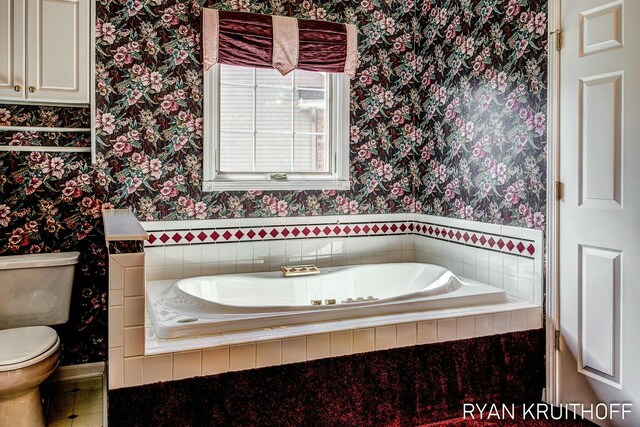 3076 Regency Pkwy, Zeeland, MI 49464 - bathroom featuring a bath, toilet, and wallpapered walls