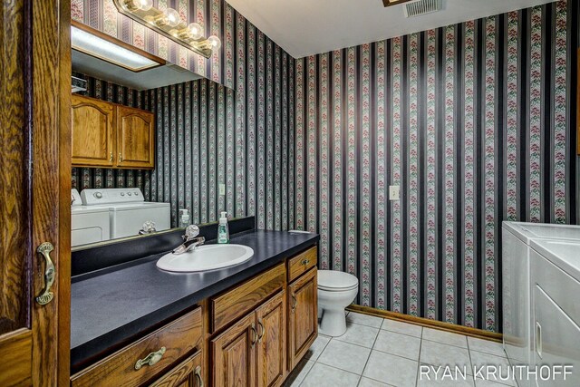3076 Regency Pkwy, Zeeland, MI 49464 - bathroom with wallpapered walls, independent washer and dryer, and tile patterned floors