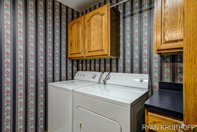 3076 Regency Pkwy, Zeeland, MI 49464 - laundry area featuring separate washer and dryer and cabinet space