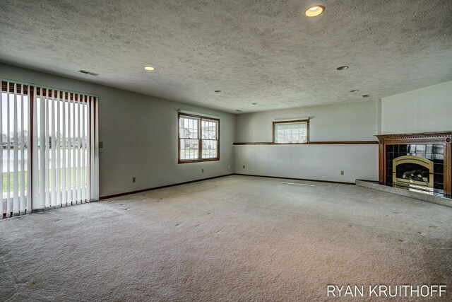 3076 Regency Pkwy, Zeeland, MI 49464 - unfurnished living room with carpet, a textured ceiling, and recessed lighting