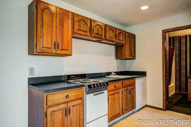 3076 Regency Pkwy, Zeeland, MI 49464 - kitchen with dark countertops, dishwasher, a sink, white range with electric cooktop, and light colored carpet