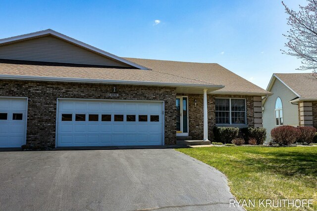 3076 Regency Pkwy, Zeeland, MI 49464 - ranch-style house with driveway, a shingled roof, a front yard, a garage, and brick siding