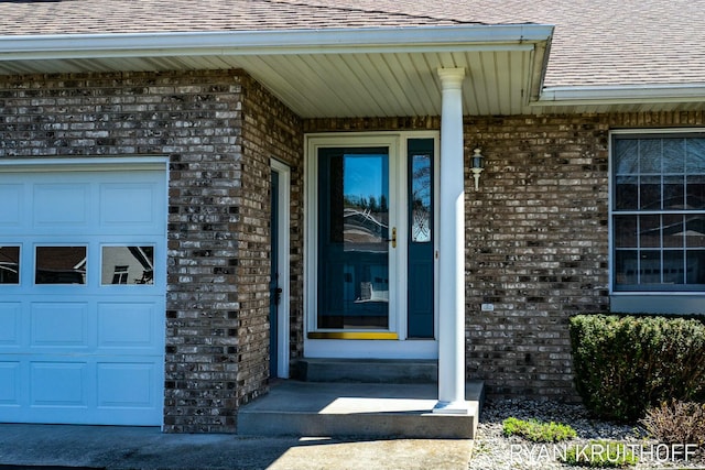 3076 Regency Pkwy, Zeeland, MI 49464 - property entrance with brick siding, an attached garage, and roof with shingles