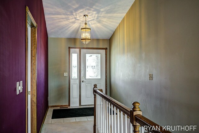 3076 Regency Pkwy, Zeeland, MI 49464 - foyer with baseboards, an inviting chandelier, and light tile patterned floors