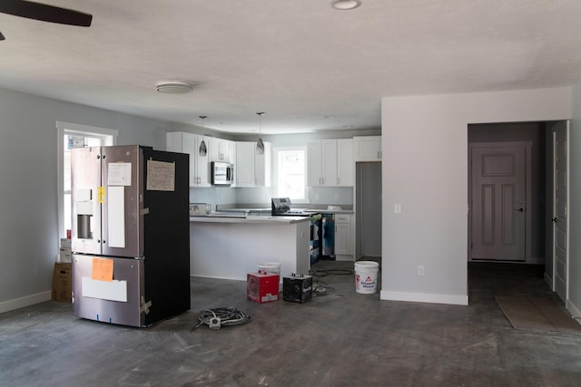 1024 Clinton Ave, Kalamazoo, MI 49001 - kitchen featuring baseboards, appliances with stainless steel finishes, hanging light fixtures, and white cabinetry
