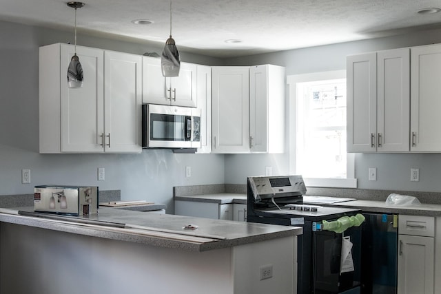 1024 Clinton Ave, Kalamazoo, MI 49001 - kitchen with white cabinets, hanging light fixtures, stainless steel appliances, and recessed lighting